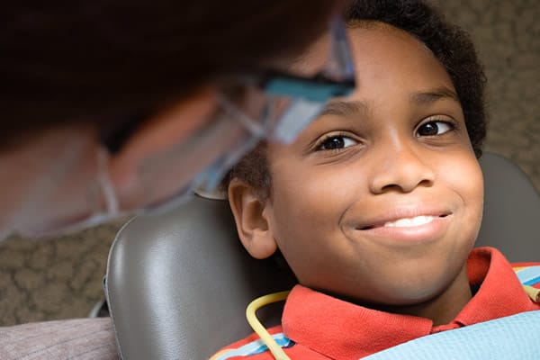 Boy smiling during dental cleaning